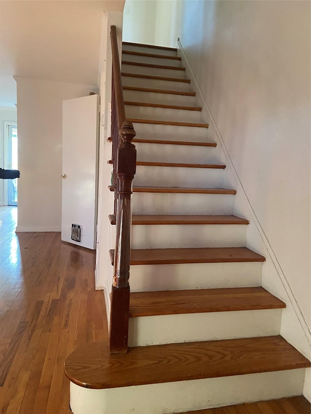 stairway featuring wood finished floors