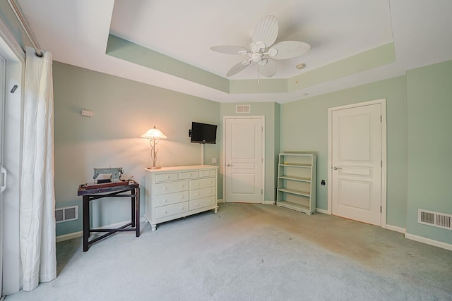 bedroom featuring a raised ceiling and visible vents