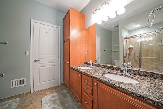 full bath with toilet, a sink, visible vents, and tile patterned floors