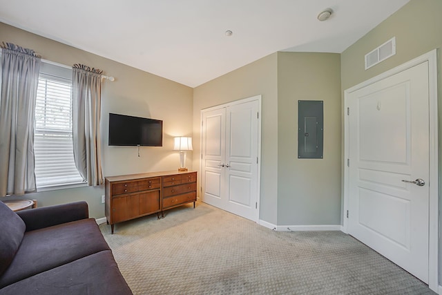 living room with light carpet, baseboards, electric panel, and visible vents