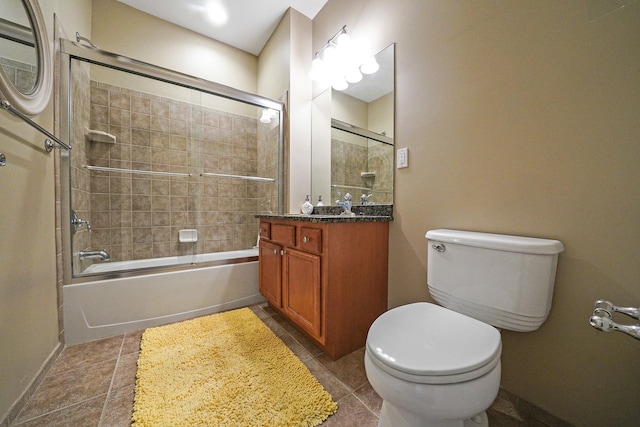 full bath with baseboards, toilet, enclosed tub / shower combo, tile patterned flooring, and vanity