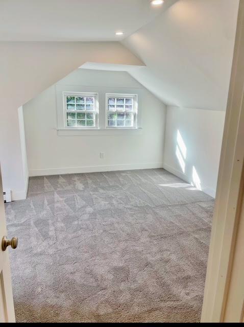 bonus room featuring baseboards, light colored carpet, baseboard heating, vaulted ceiling, and recessed lighting