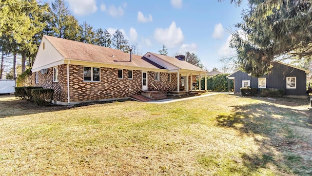 155 Shepard Dr, Southold, NY 11971 - back of property featuring brick siding and a lawn