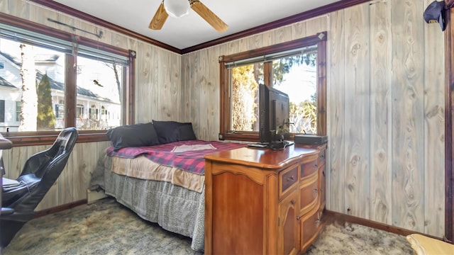 155 Shepard Dr, Southold, NY 11971 - bedroom featuring ornamental molding, a ceiling fan, light carpet, wood walls, and baseboards