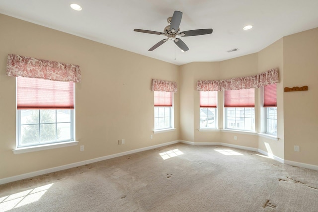 carpeted empty room featuring recessed lighting, visible vents, baseboards, and a ceiling fan