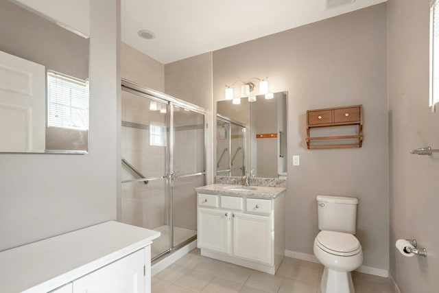 bathroom featuring vanity, tile patterned floors, toilet, and a stall shower