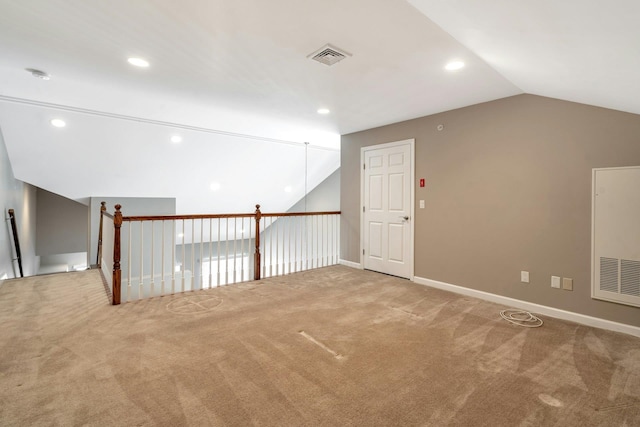 spare room with visible vents, recessed lighting, carpet flooring, baseboards, and vaulted ceiling