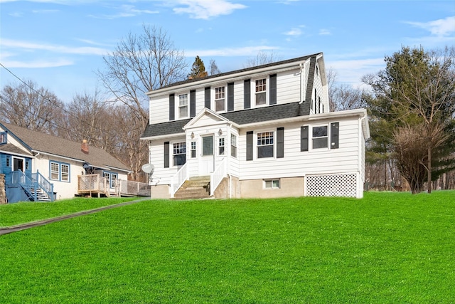 view of front facade featuring a shingled roof, entry steps, and a front lawn