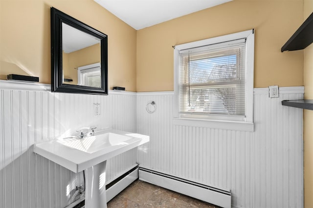 bathroom featuring a wainscoted wall, a baseboard heating unit, and baseboard heating