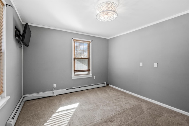 spare room featuring a baseboard radiator, light colored carpet, crown molding, and baseboards