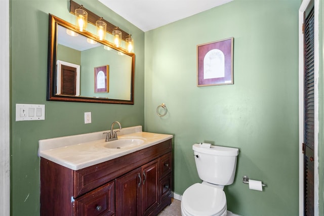 bathroom with toilet and vanity