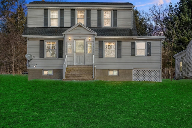 view of front of house featuring a front yard and roof with shingles