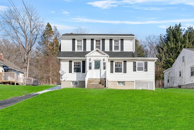 view of front of home with a shingled roof and a front yard