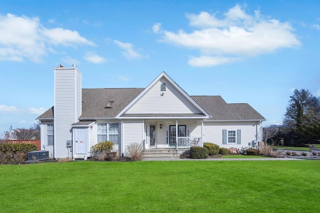 view of front of home featuring central AC, a porch, a chimney, and a front lawn