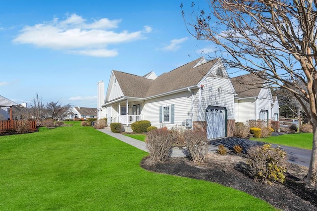 view of property exterior featuring covered porch, a lawn, an attached garage, and a chimney