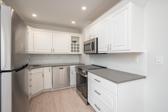 kitchen with appliances with stainless steel finishes, dark countertops, and white cabinetry