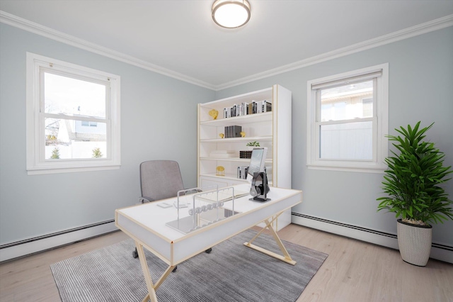 office space featuring a baseboard heating unit, light wood-type flooring, and crown molding