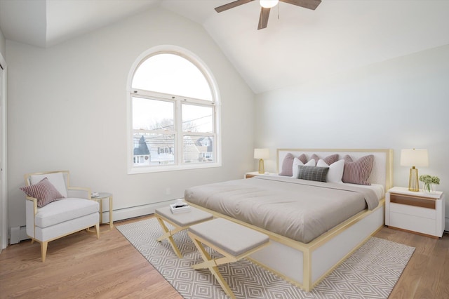 bedroom with lofted ceiling, ceiling fan, light wood-style flooring, a baseboard heating unit, and baseboard heating