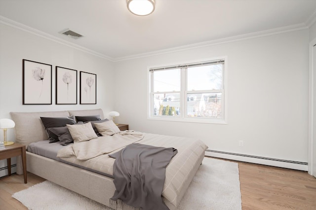 bedroom with crown molding, a baseboard radiator, visible vents, and light wood-style floors