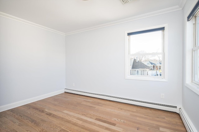 unfurnished room featuring a healthy amount of sunlight, a baseboard radiator, and crown molding