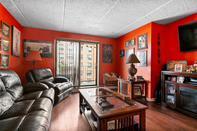 living area featuring wood-type flooring, baseboards, and a glass covered fireplace