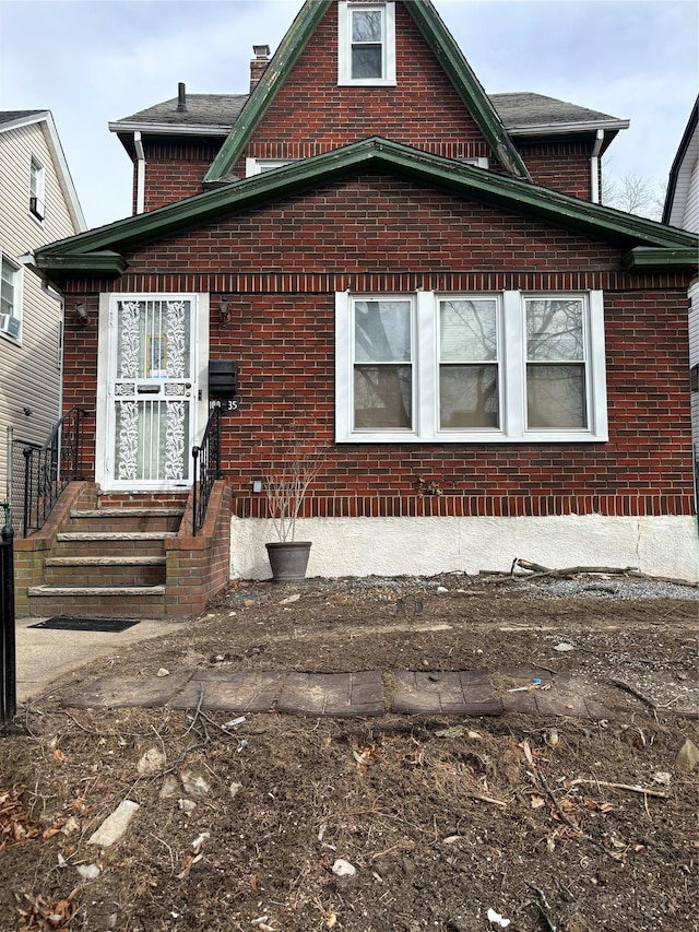 exterior space featuring entry steps and brick siding