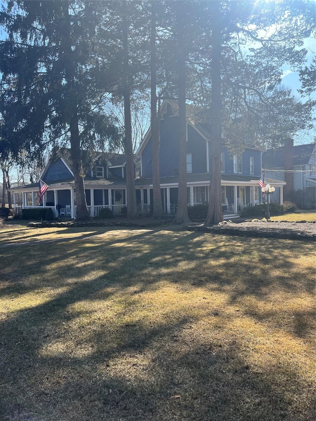 back of property with a lawn