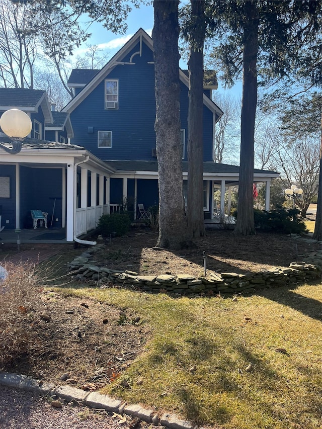 rear view of property with a lawn