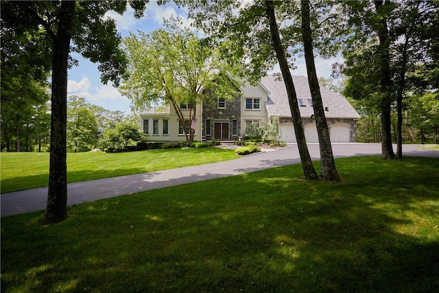 traditional-style house featuring driveway and a front yard