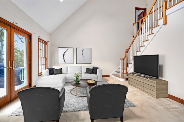 living room featuring stairs, high vaulted ceiling, french doors, and baseboards