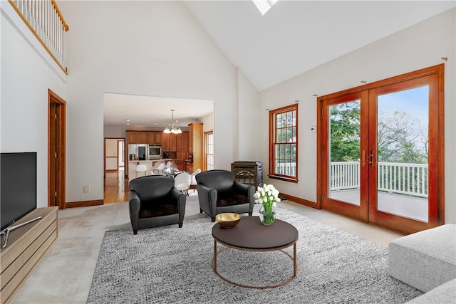 living room featuring french doors, light carpet, a notable chandelier, and baseboards