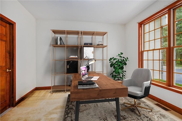 office area with baseboards, visible vents, and a wealth of natural light