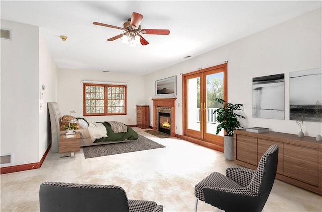 living room with a fireplace with flush hearth, a healthy amount of sunlight, light carpet, and baseboards