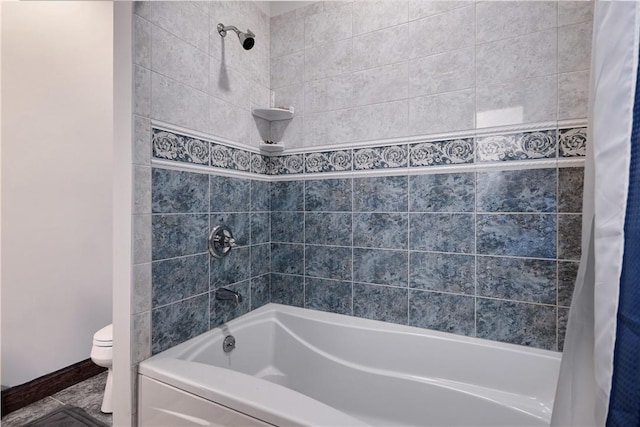 bathroom with toilet, baseboards, and shower / bath combination with curtain