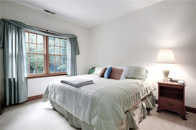 bedroom featuring light colored carpet, visible vents, and baseboards