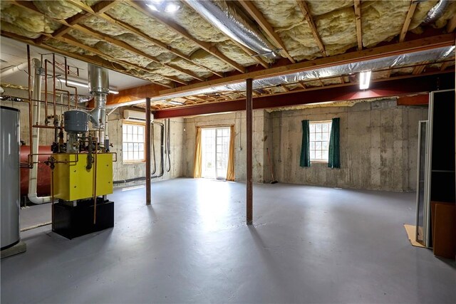 basement featuring a wall unit AC and water heater