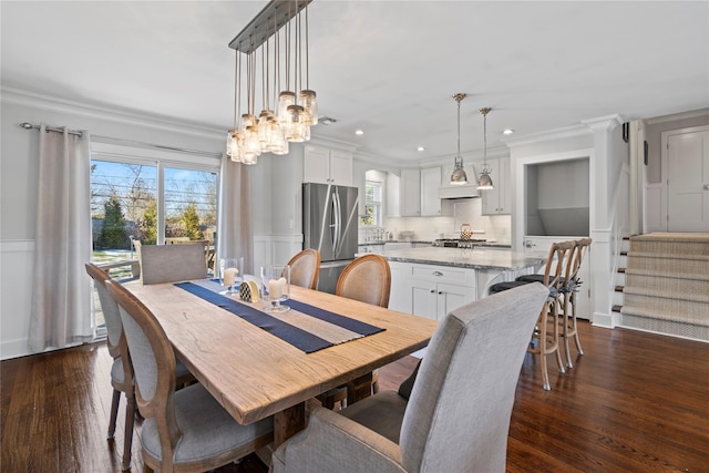 dining area featuring stairway, plenty of natural light, dark wood-style floors, and ornamental molding