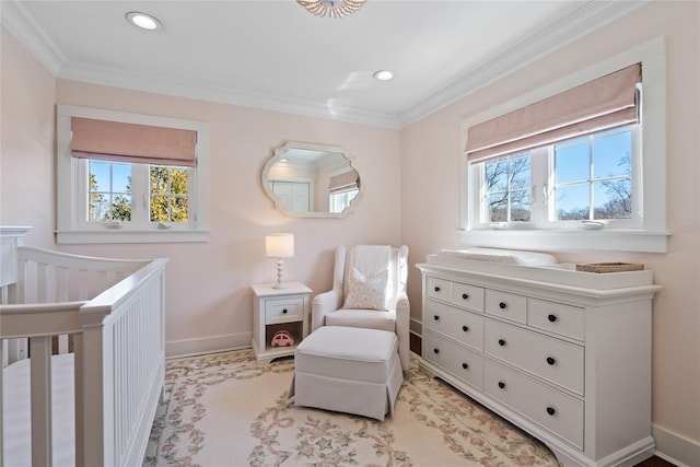 bedroom featuring ornamental molding, a crib, and multiple windows