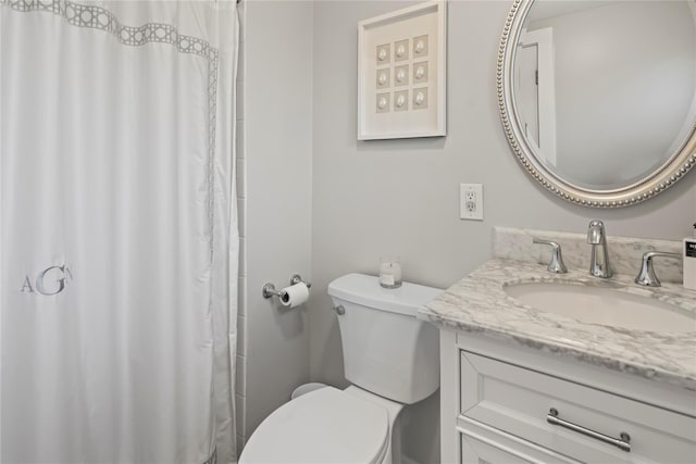 full bathroom with toilet, vanity, and a shower with curtain