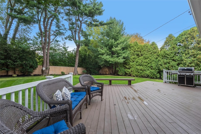 wooden deck with a fenced backyard, grilling area, and a yard