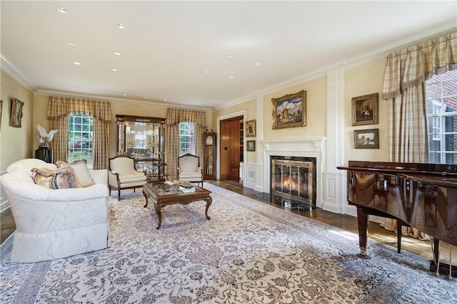 living area featuring ornamental molding, a fireplace with flush hearth, and recessed lighting