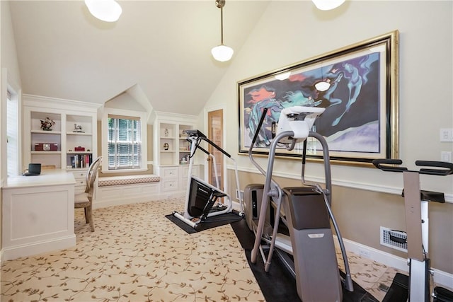 workout room with vaulted ceiling, light carpet, baseboards, and built in features