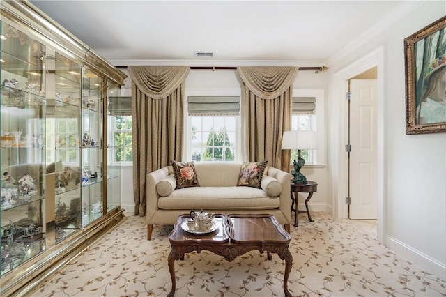 living area with visible vents, crown molding, and baseboards