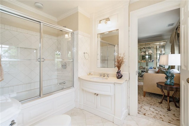 full bathroom featuring visible vents, bath / shower combo with glass door, ensuite bath, crown molding, and vanity