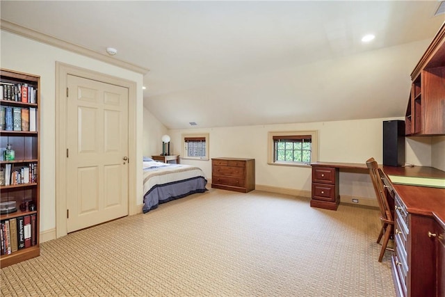 bedroom with lofted ceiling, recessed lighting, built in study area, light carpet, and baseboards