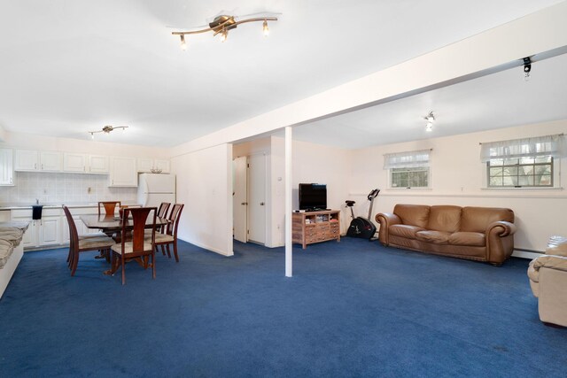dining area with dark carpet and a baseboard heating unit