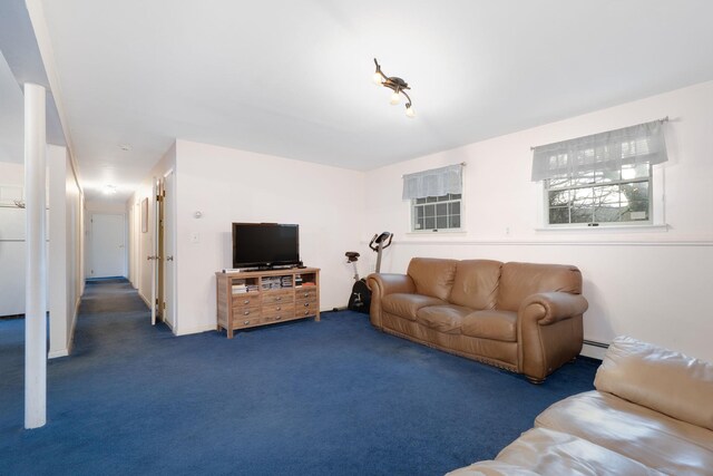 carpeted living area featuring a baseboard heating unit