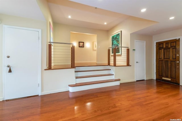 entryway featuring stairs, baseboards, wood finished floors, and recessed lighting