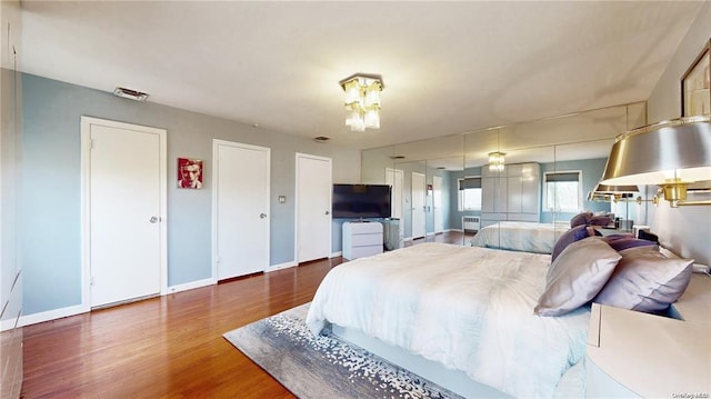 bedroom featuring baseboards and wood finished floors