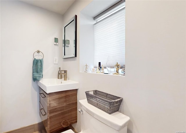 half bathroom featuring toilet and vanity